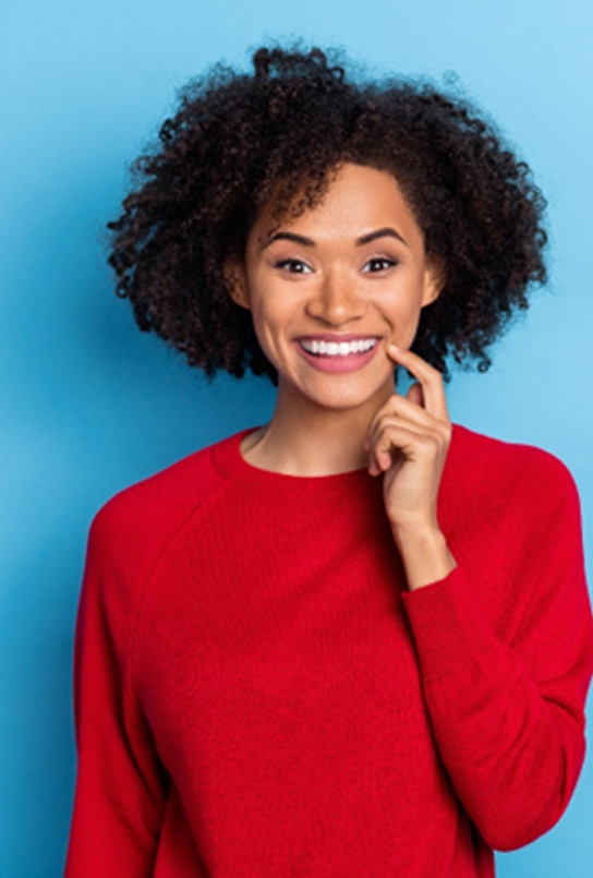 Woman showing off teeth whitening results in Maple Valley